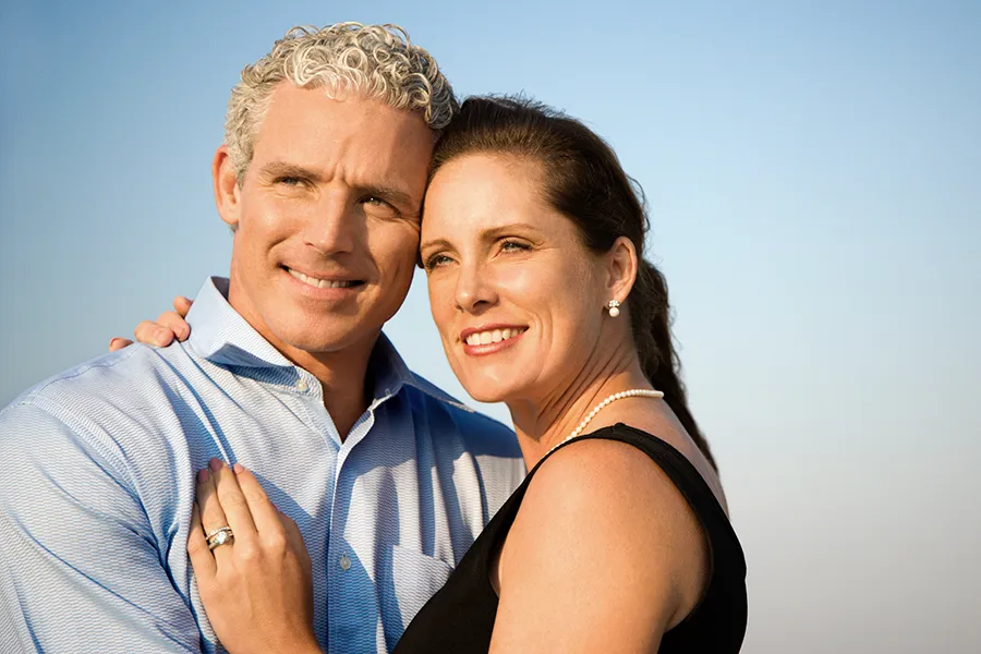 Healthy-Aging-Peptides-Doctor A middle-aged caucasian couple embraces in the sunshine, happy with the healthy aging peptide treatments from Dr. David Lans in New Rochelle