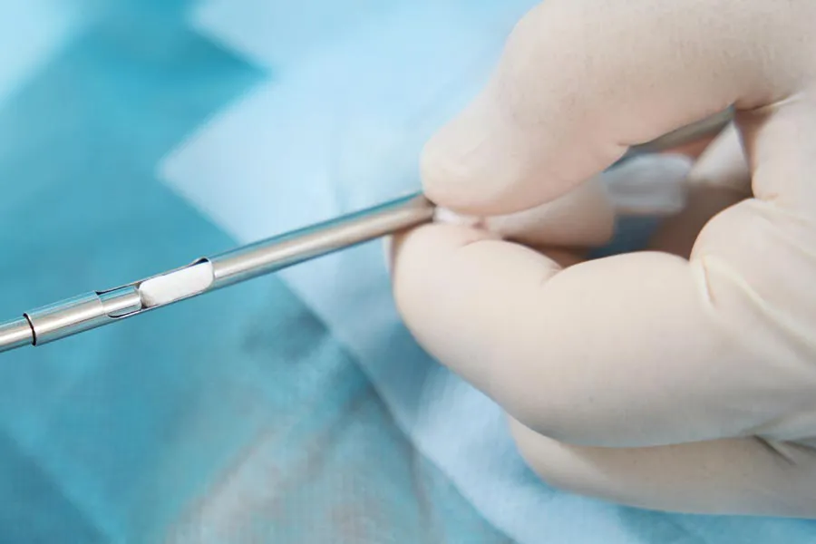 Hormone-Pellet-Therapy Close up of a doctor inserting a hormone pellet into a delivery device for hormone pellet treatments from Dr. David Lans in New Rochelle.