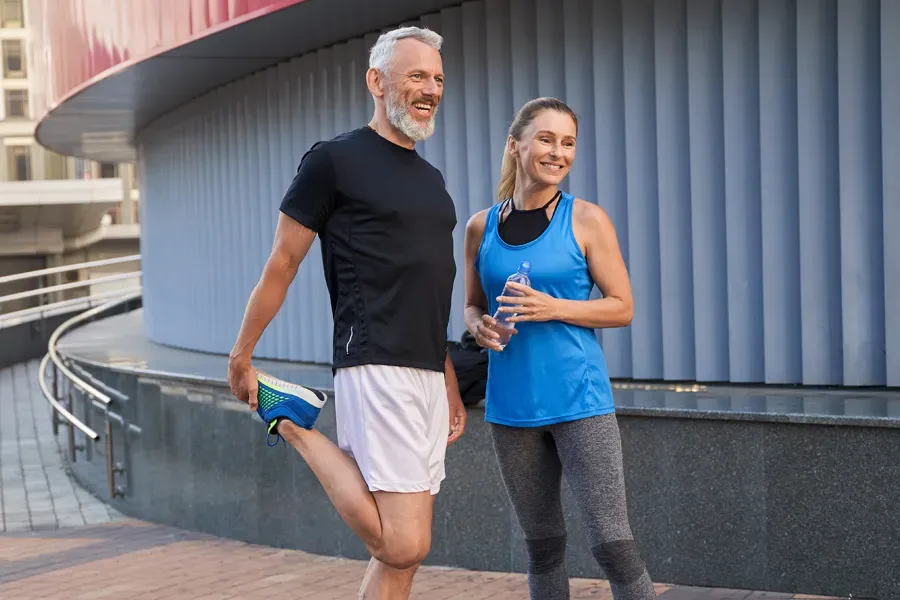 Peptides-for-Healing-and-Recovery-Doctor A middle-aged couple happily stretch and prepare for exercise after receiving effective peptide therapy for healing and recovery from Dr. David Lans in New Rochelle.