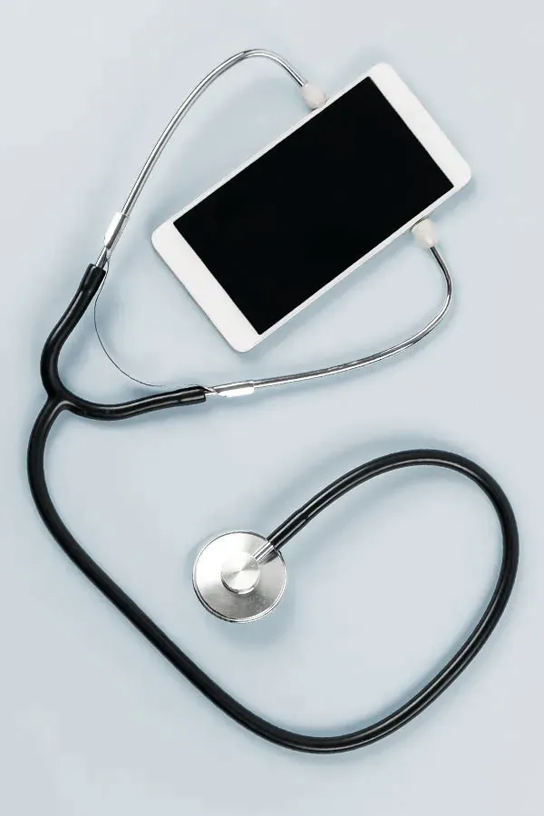 Telemedicine-Treatment A smartphone with a stethoscope attached to it, symbolizing Telemedicine treatment from Dr. David Lans in New Rochelle.