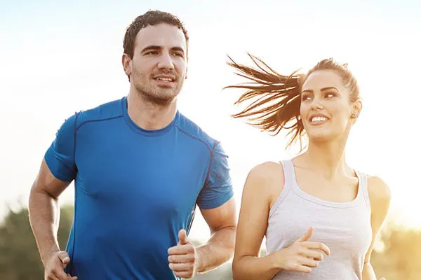 Weight-Loss-Resistance-Doctor A couple happily jogging in the sunlight after receiving effective weight loss resistance care from Dr. David Lans in New Rochelle.