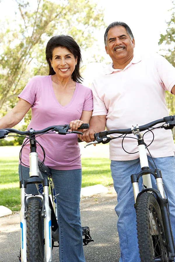 integrative-medicine-services-westchester-county-ny Middle-aged healthy couple riding bikes in Westchester County